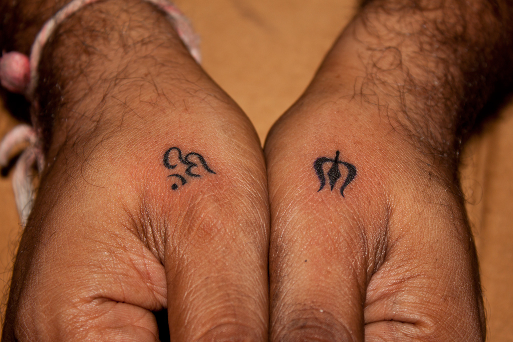 Black Little Trishul With Om Tattoo On Man Both Hand By Javagreeen