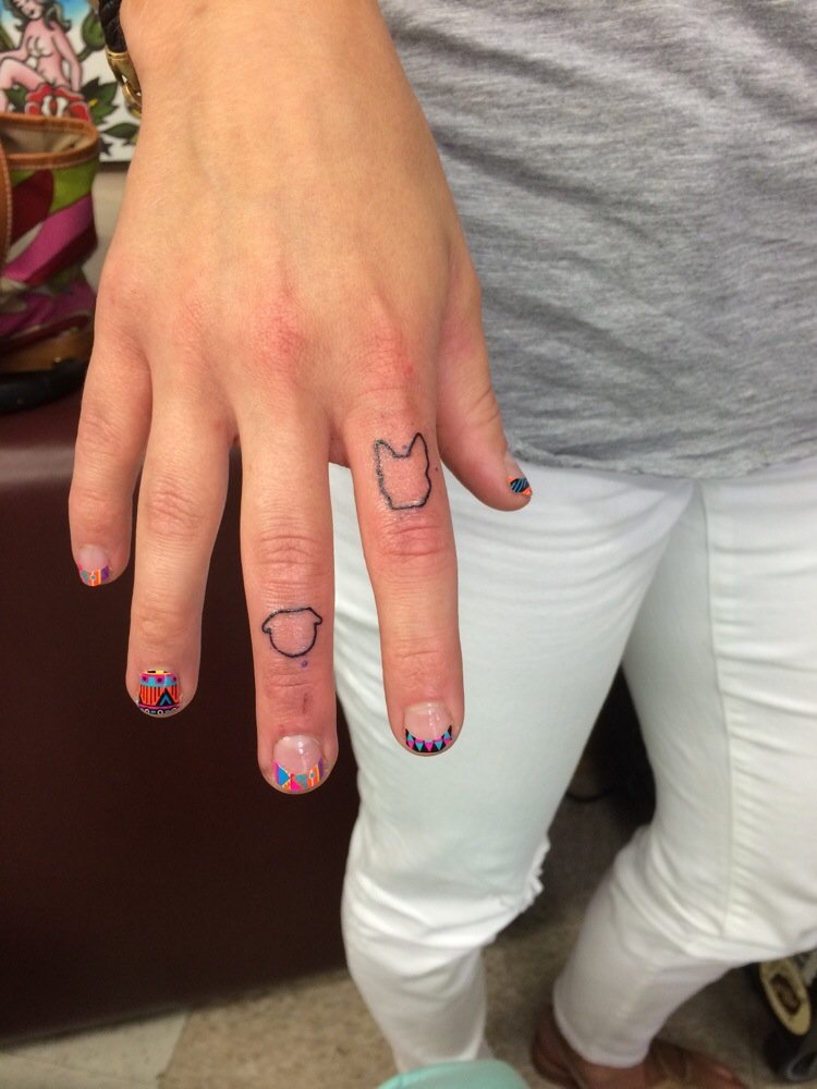 Black Outline Pug And Bulldog Tattoo On Girl Fingers