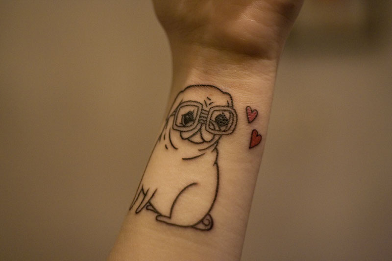 Black Outline Pug Dog Tattoo On Wrist