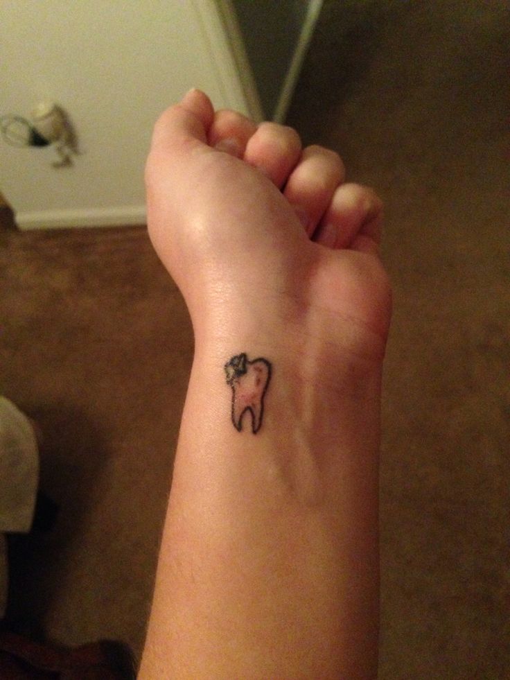 Black Outline Teeth With Bow Tattoo On Wrist