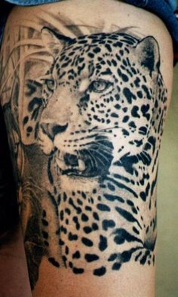 Black ink Leopard tattoo on thigh