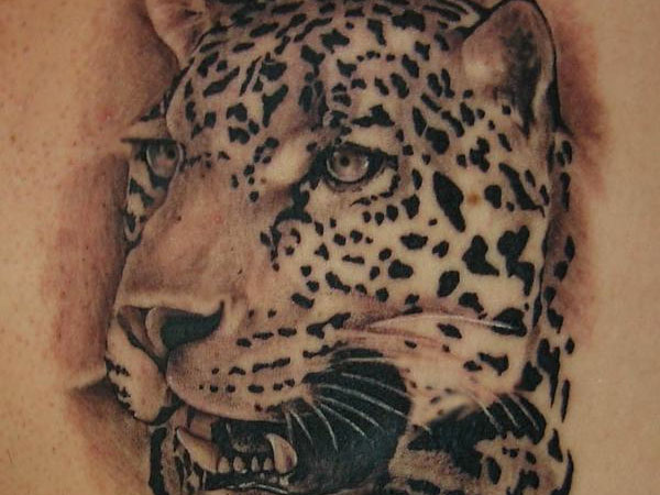 Black ink leopard face tattoo