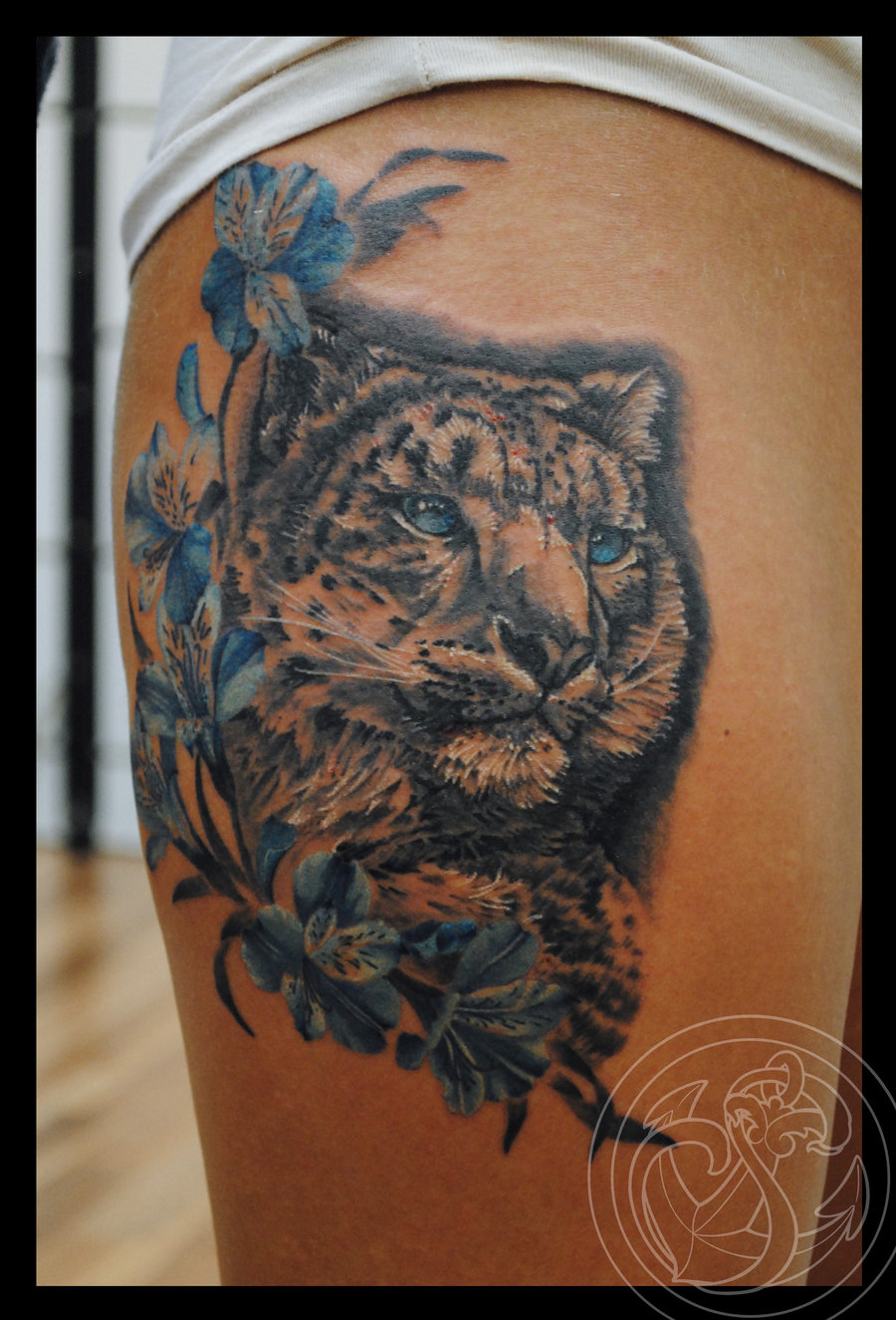 Blue Flowers And Snow Leopard Tattoo On Girl Right Thigh