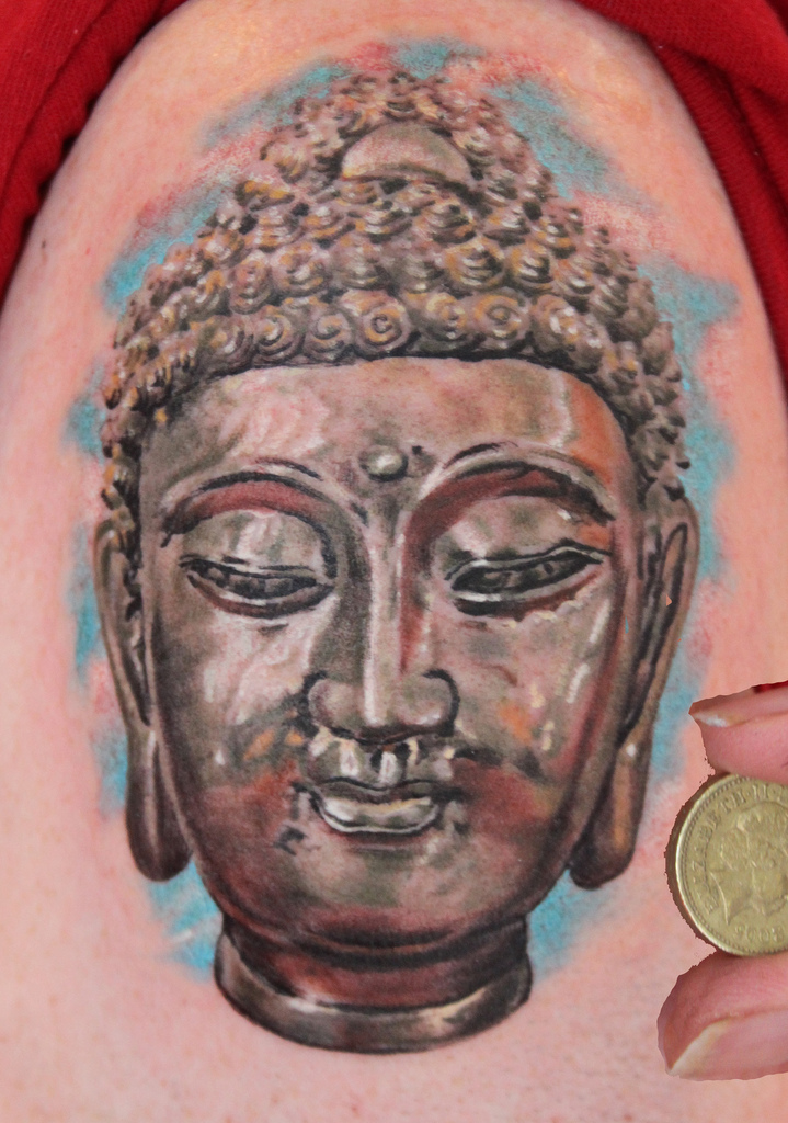 Buddha head statue tattoo design