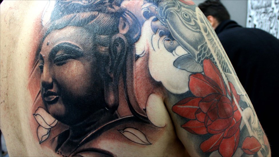 Buddha head tattoo design on back shoulder
