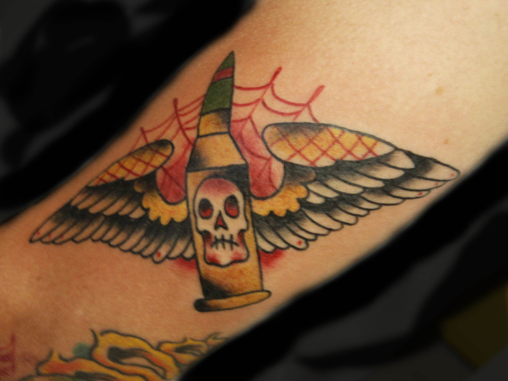 Colorful Bullet With Wings Tattoo Design For Arm