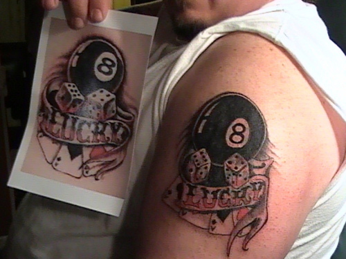 Eight Ball With Dice And Banner Tattoo On Man Left Shoulder