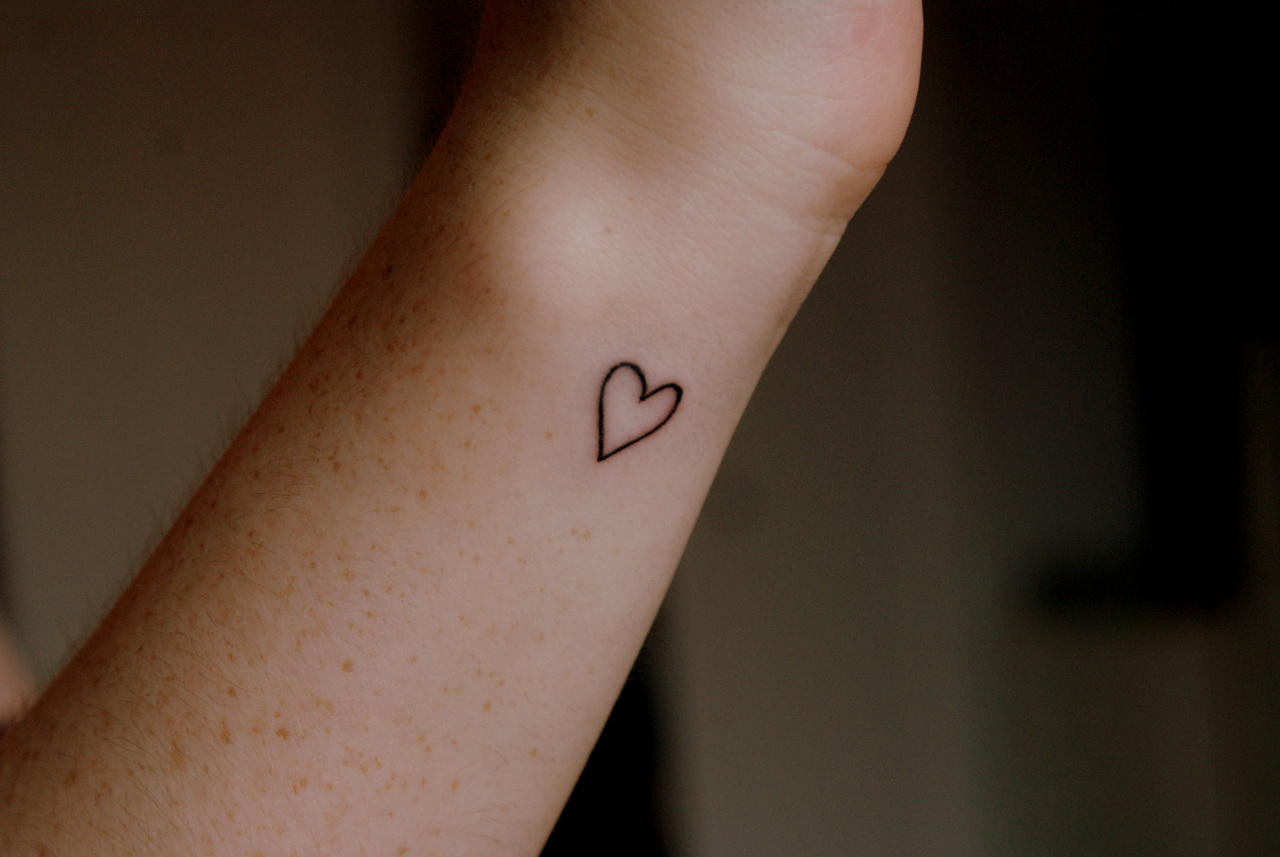Girl Showing Her Simple Heart Tattoo