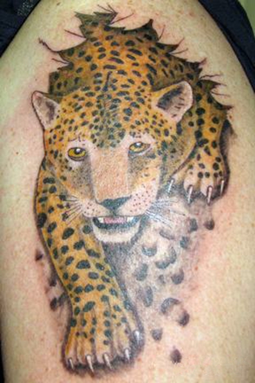 Leopard coming out of ripped skin tattoo