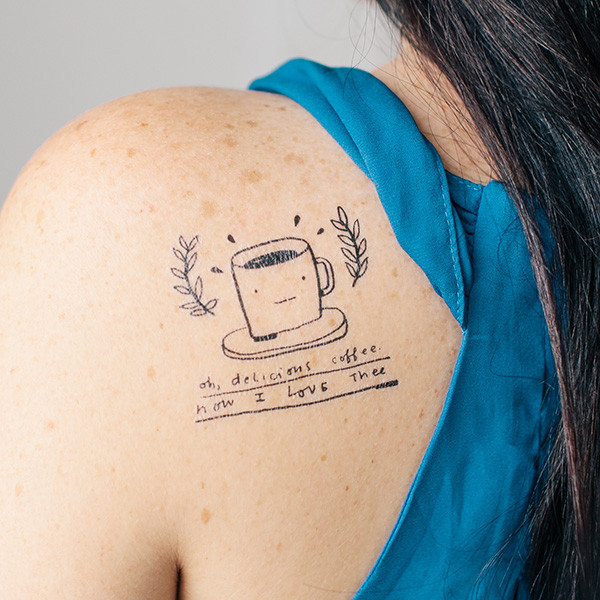Oh Delicious Coffee – Black Coffee Cup Tattoo On Girl Left Back Shoulder