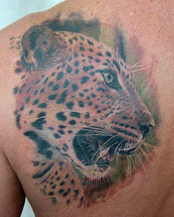 Roaring leopard head tattoo on back shoulder