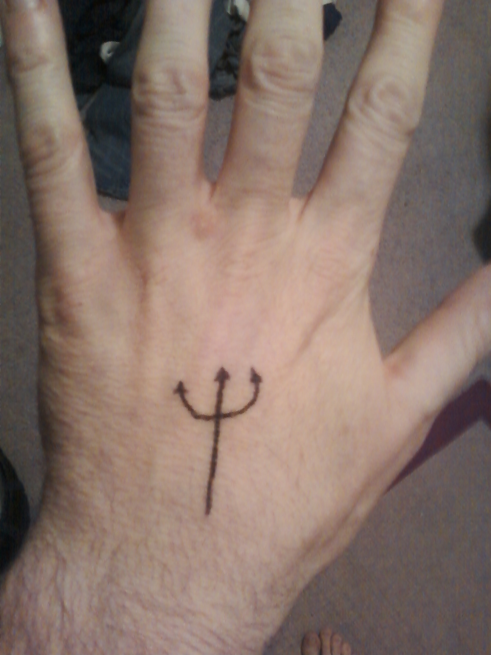 Simple Black Trishul Tattoo On Hand