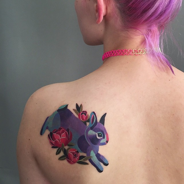 Unique Purple Rabbit With Flowers Tattoo On Girl Left Back Shoulder