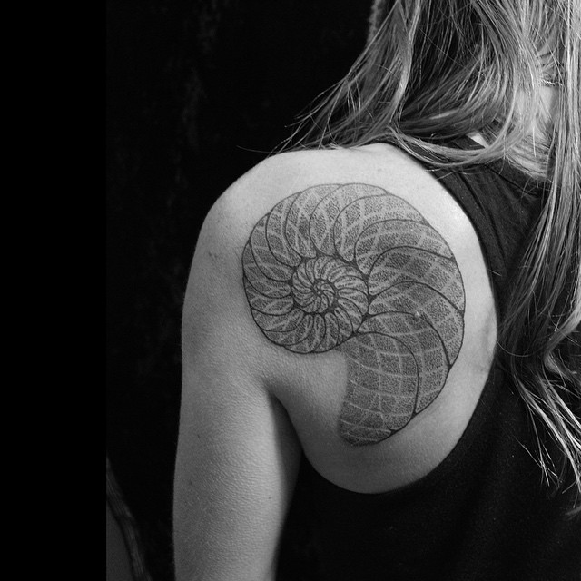Unique Spiral Shell Tattoo On Girl Left Back Shoulder By Oliver Kenton