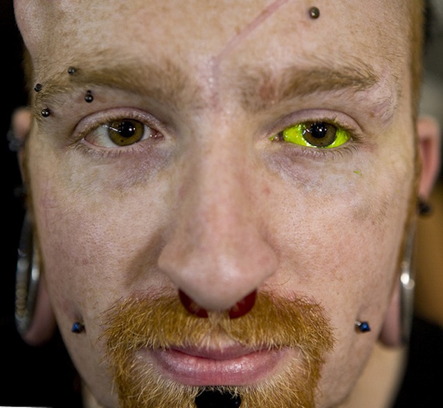 Yellow Ink Man Left Eyeball Tattoo