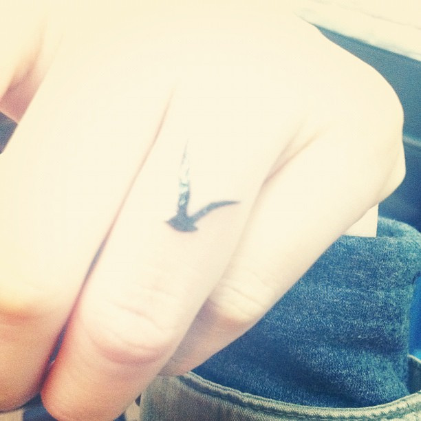 Black Ink Flying Seagull Tattoo On Finger By Teatone
