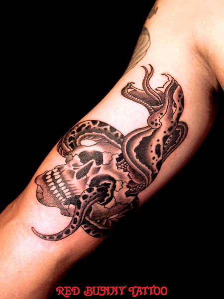Black Ink Rattlesnake With Skull Tattoo On Bicep