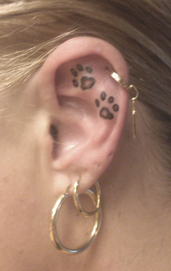 Black Ink Two Leopard Paw Prints Tattoo On Ear By Sanne