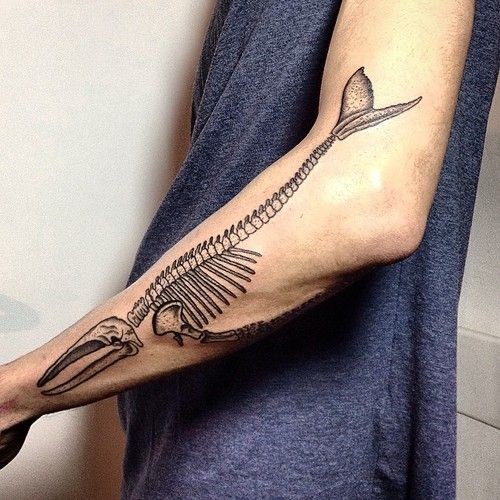 Black Ink Whale Skeleton Tattoo On Left Arm
