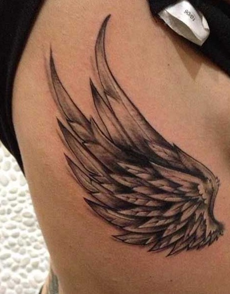 Black Ink Wing Tattoo On Upper Rib By Eric Richardz