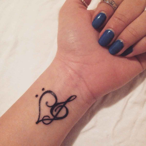 Black Treble Clef Heart Tattoo On Wrist