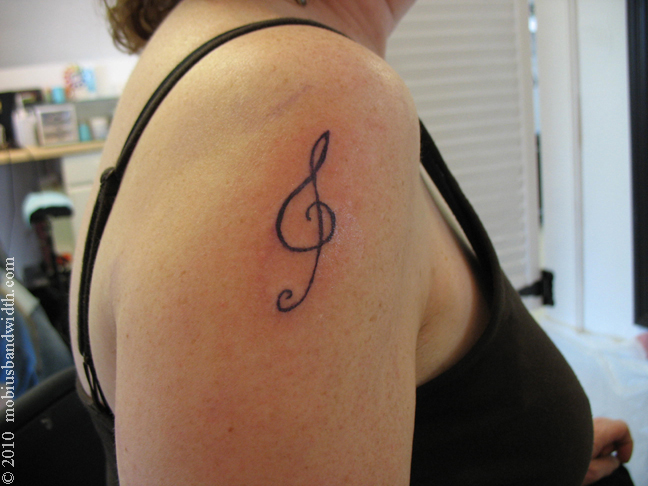 Black Treble Clef Tattoo On Girl Right Shoulder By James Mobius