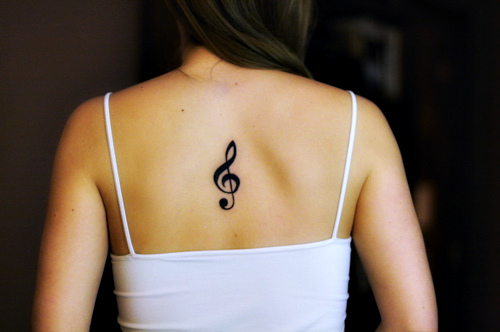 Black Treble Clef Tattoo On Girl Upper Back By LauraReaux