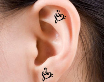 Black Two Treble Clef Heart Tattoo On Ear