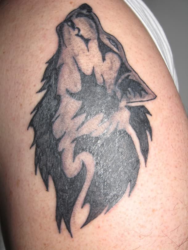 Grey And Black Ink Tribal Howling Wolf Head Tattoo