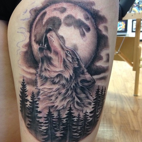 Grey Full Moon And Wolf Head Tattoo On Thigh