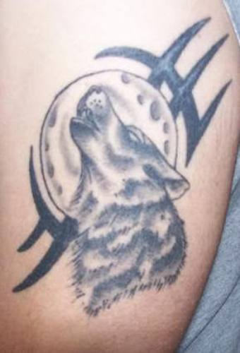 Grey Ink Simple Tribal And Howling Wolf Head Tattoo On Left Bicep