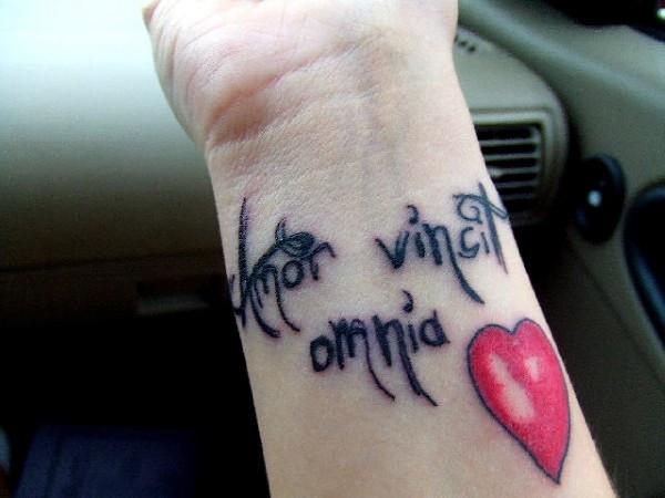Red Heart And Love Quote Tattoo On Wrist