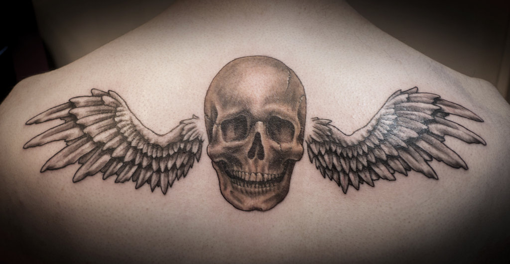 Skull With Wings Tattoo On Upper Back By Anthony Noble