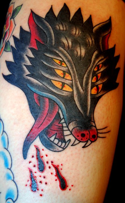Three Eyes Traditional Wolf Head Tattoo On Bicep