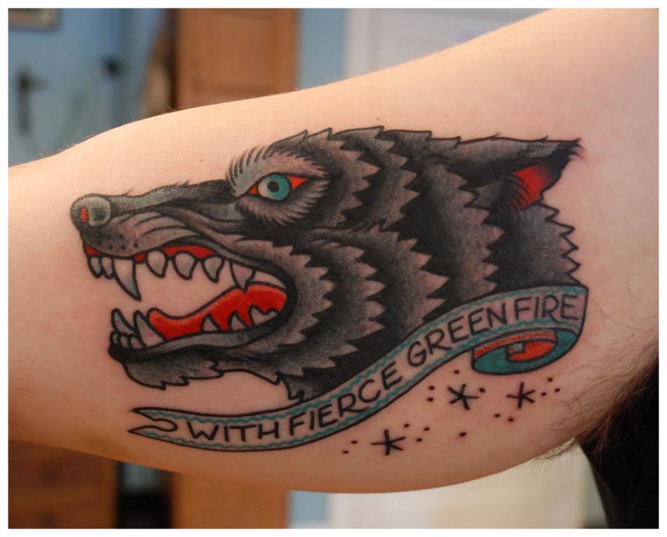 Traditional Wolf Head With Fierce Green Fire Banner Tattoo On Inner Bicep