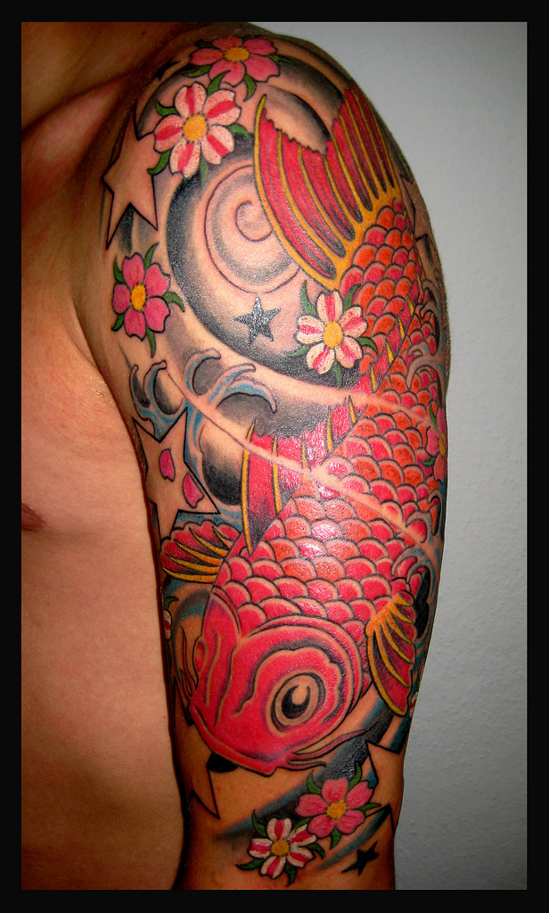 Amazing Asian Koi Fish With Flowers Tattoo On Man Left Sleeve