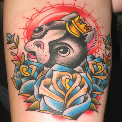 Amazing cartoon puppy with crown and roses tattoo