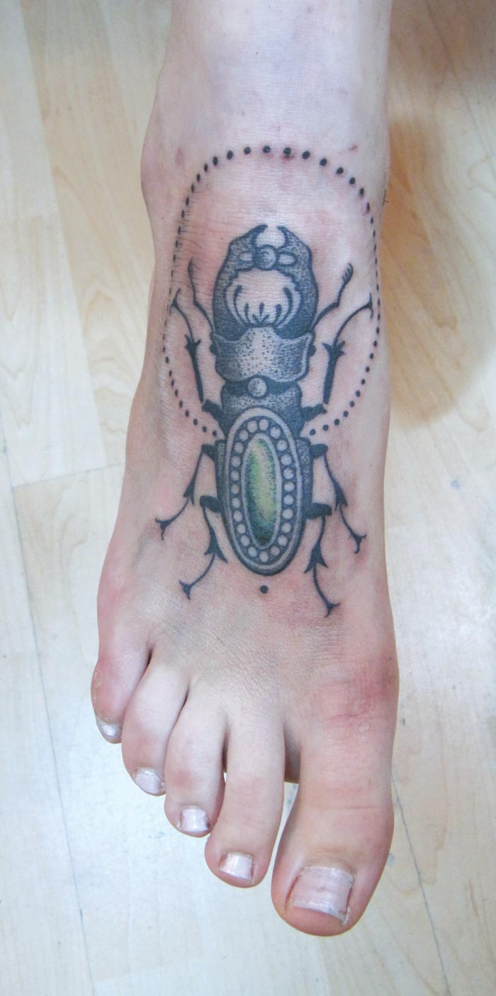 Awesome Black Ink Beetle Tattoo On Foot
