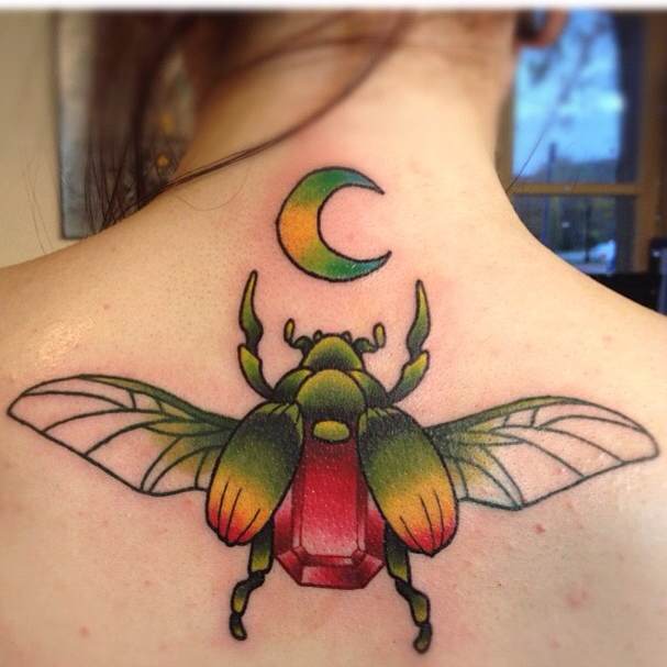 Awesome Colorful Beetle With Half Moon Tattoo On Girl Upper Back