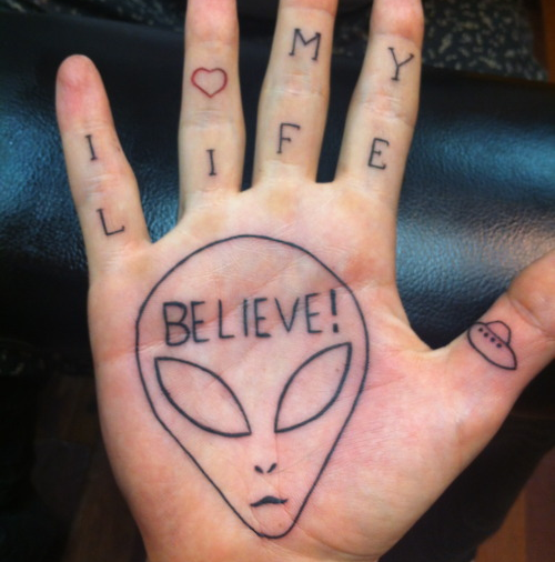 Believe Word In Alien Head Tattoo On Palm