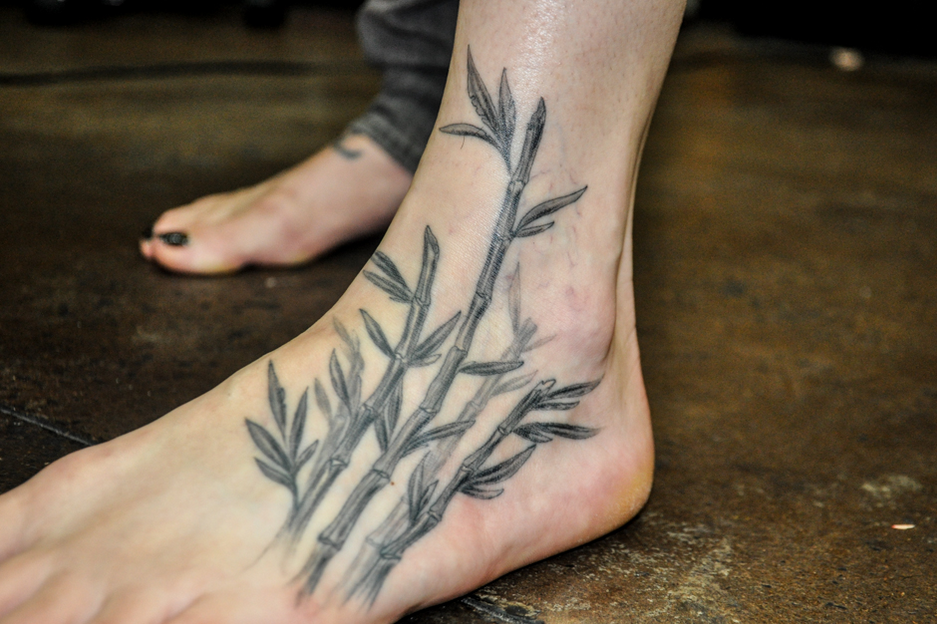 Black And Grey Bamboo Trees Tattoo On Girl Foot