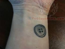 Black And Grey Button Tattoo On Wrist