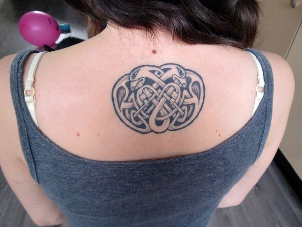 Black And Grey Ink Celtic Love Tattoo On Girl Upper Back