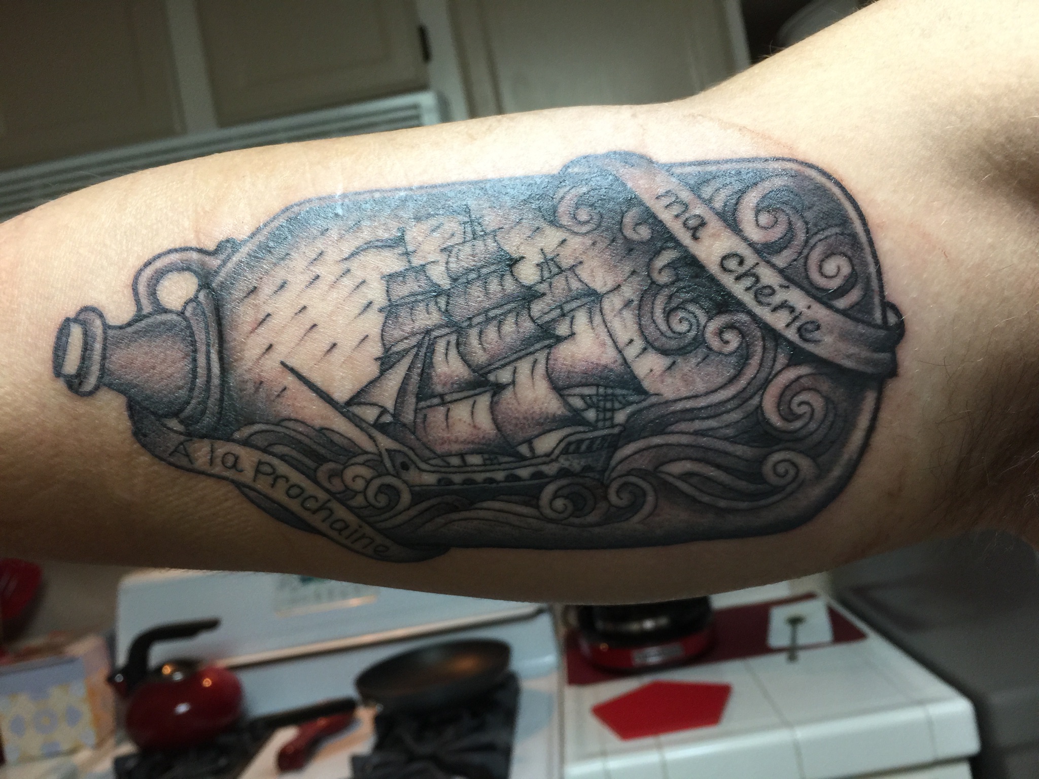 Black And Grey Ship In Bottle With Banner Tattoo On Bicep By Aaron Mason