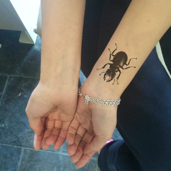 Black Beetle Tattoo On Wrist