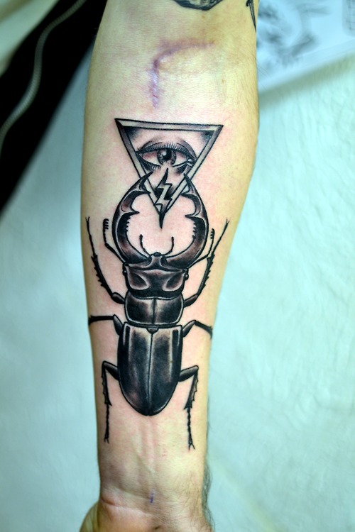 Black Beetle With Illuminati Eye Tattoo On Forearm