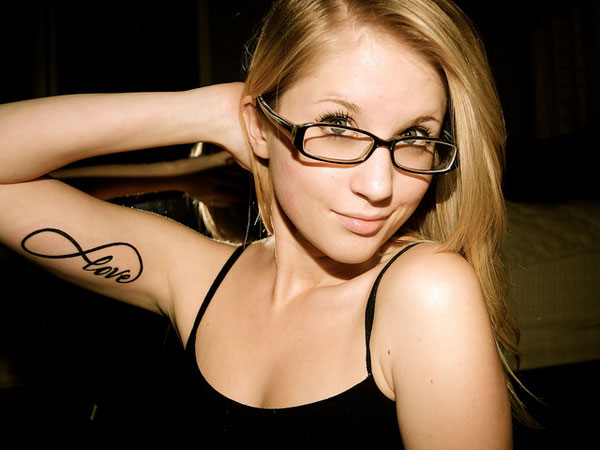 Black Infinity Love Tattoo On Girl Right Bicep