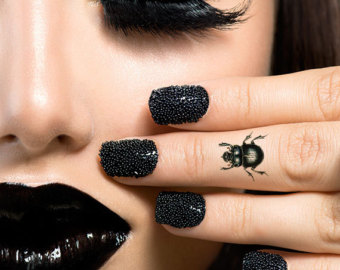 Black Ink Beetle Tattoo On Girl Finger
