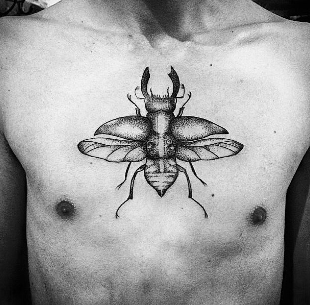 Black Ink Beetle Tattoo On Man Chest