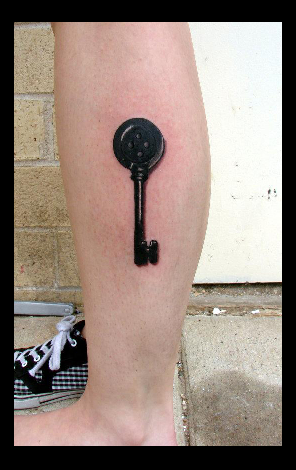 Black Ink Button Key Tattoo On Leg